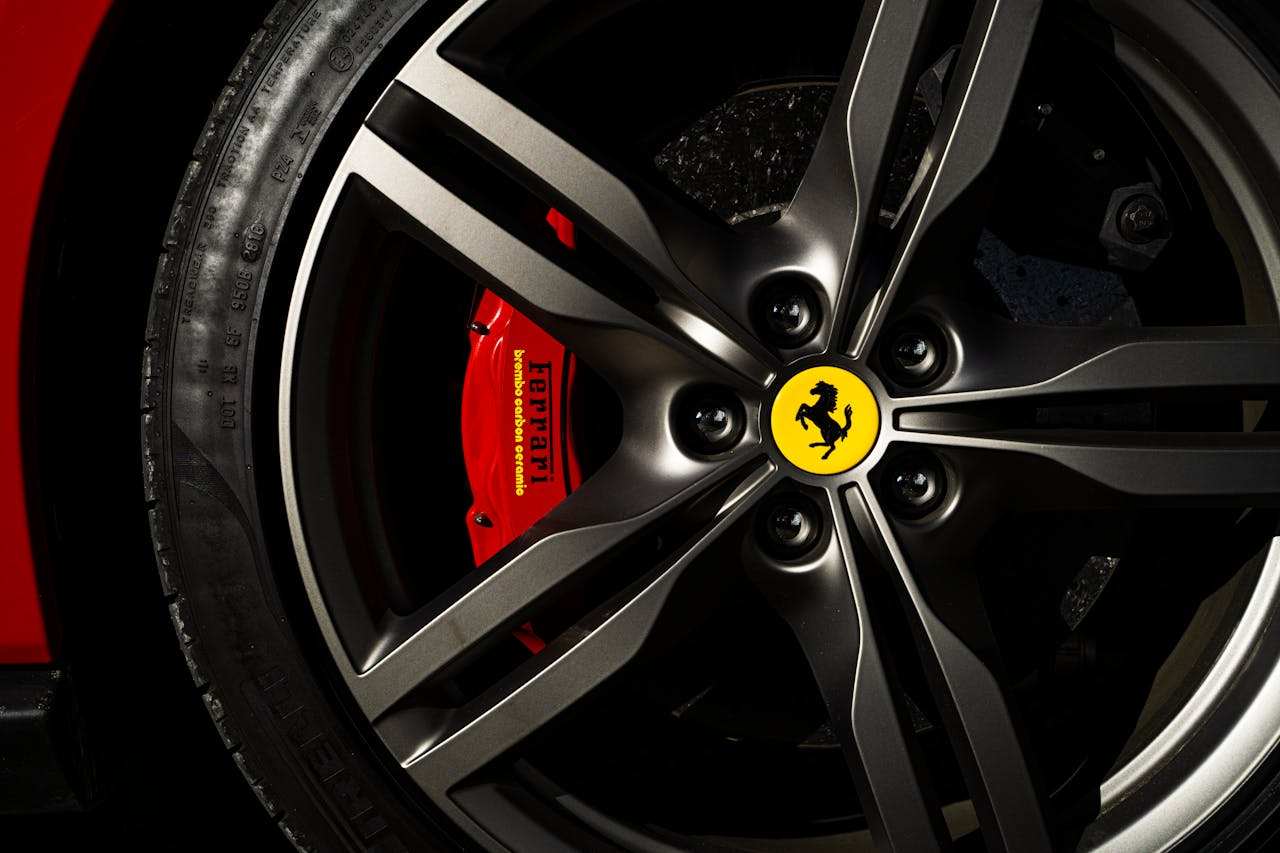 Next Day Tyres – Fast & Reliable Tyre Delivery UK Detailed view of a Ferrari wheel and brake showcasing luxury automotive design.